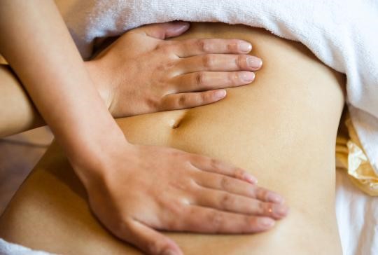young woman having stomach massage